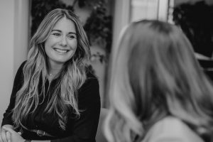 Anna Hutton, TMLA's Director of Strategic Partnerships, talking to an employee blurred in the foreground.